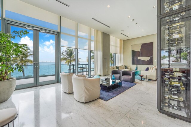 3131 NE 7th Ave Unit 3101, Miami, FL 33137 - living room featuring french doors, a water view, healthy amount of natural light, and expansive windows