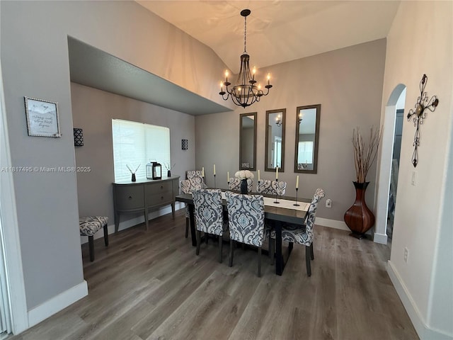 6871 SW 159th Pl, Miami, FL 33193 - dining space with arched walkways, wood finished floors, lofted ceiling, and a chandelier