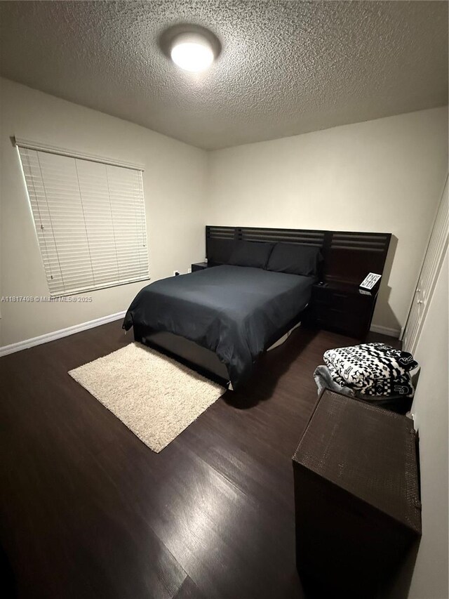 2046 NE 4th Ct, Homestead, FL 33033 - bedroom featuring wood finished floors, a textured ceiling, and baseboards