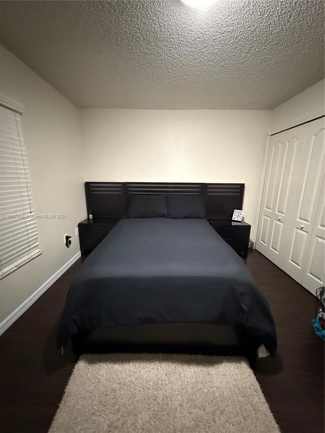 2046 NE 4th Ct, Homestead, FL 33033 - bedroom with a closet, a textured ceiling, baseboards, and carpet flooring