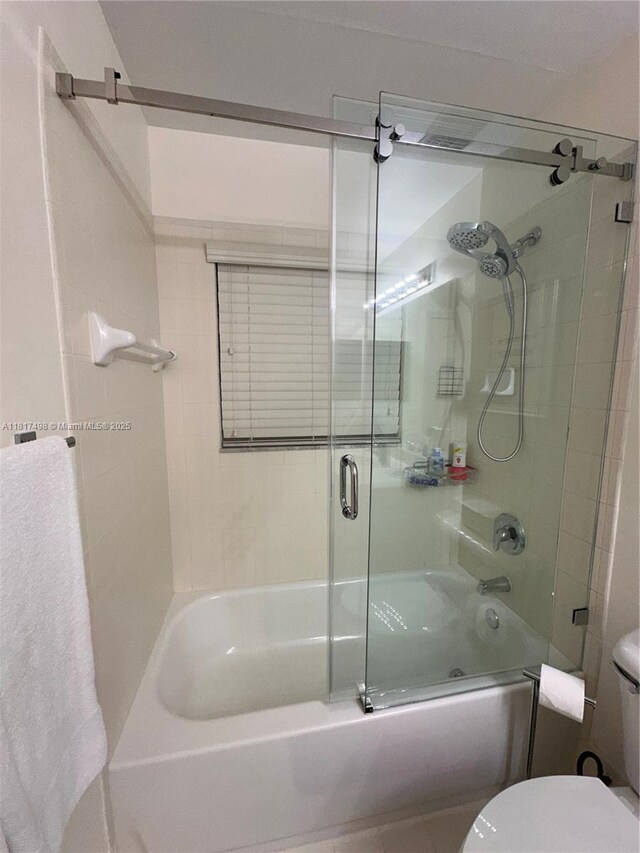 2046 NE 4th Ct, Homestead, FL 33033 - bathroom with toilet and shower / bath combination with glass door