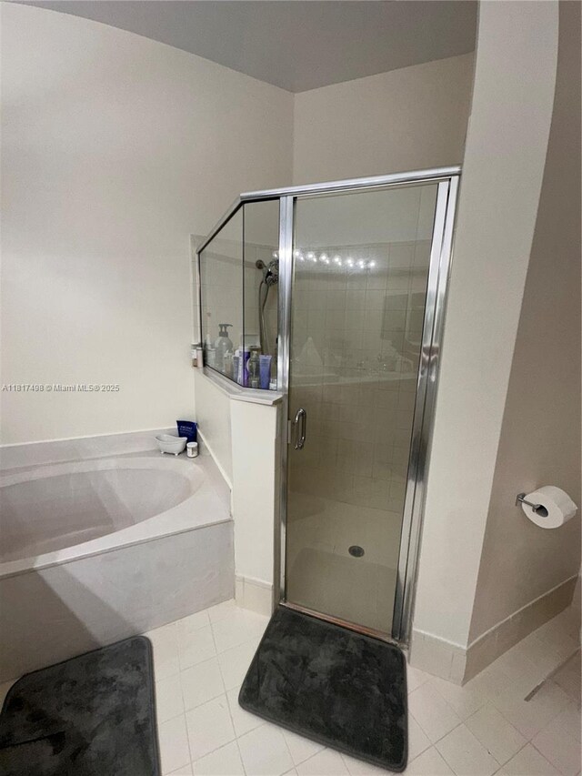 2046 NE 4th Ct, Homestead, FL 33033 - bathroom featuring a garden tub, tile patterned floors, a shower stall, and baseboards