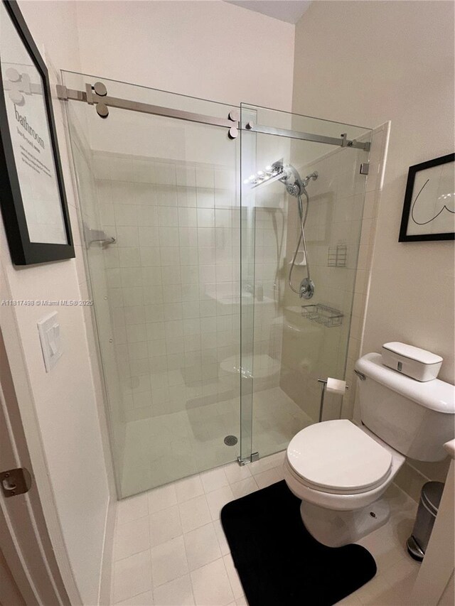 2046 NE 4th Ct, Homestead, FL 33033 - bathroom featuring a shower stall, toilet, and tile patterned floors