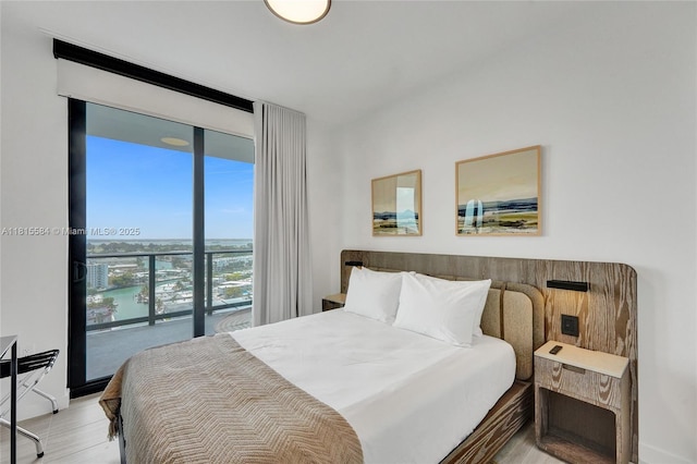 580 72nd St Unit 1712, Miami, FL 33141 - bedroom with floor to ceiling windows, wood finished floors, and a water view