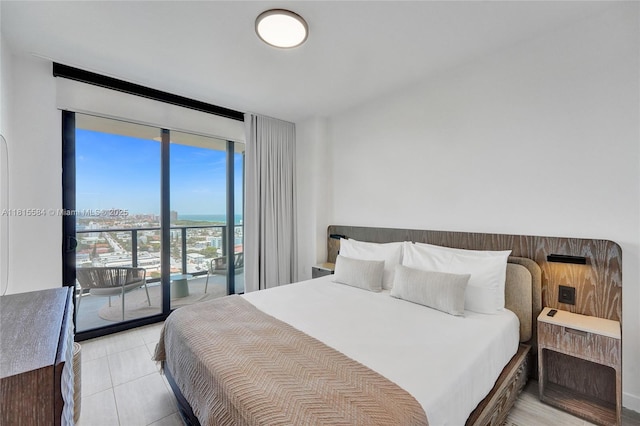 580 72nd St Unit 1712, Miami, FL 33141 - bedroom with expansive windows, access to outside, and light tile patterned flooring