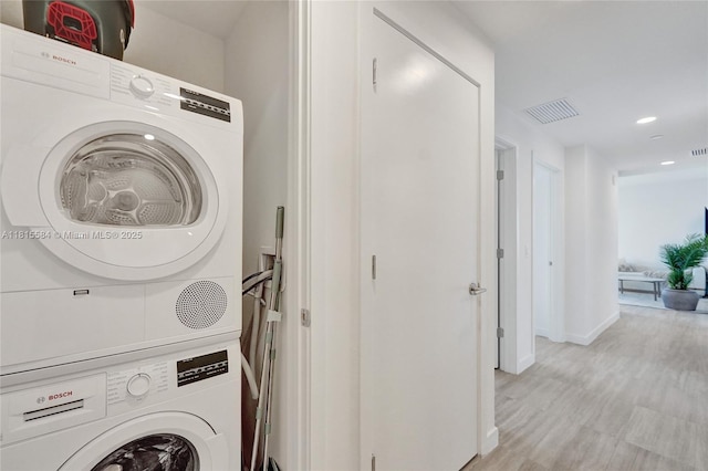 580 72nd St Unit 1712, Miami, FL 33141 - laundry area with stacked washer and clothes dryer, recessed lighting, and light wood finished floors