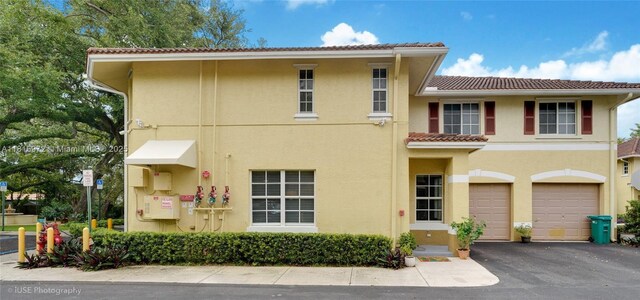 754 NE 90th St Unit 701, Miami, FL 33138 - view of front of property featuring a tile roof, stucco siding, and driveway