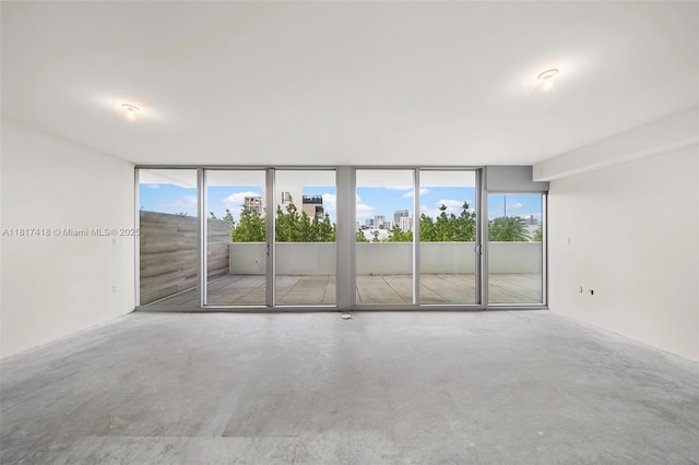 1201 20th St Unit 310, Miami Beach, FL 33139 - spare room with concrete floors and a wall of windows