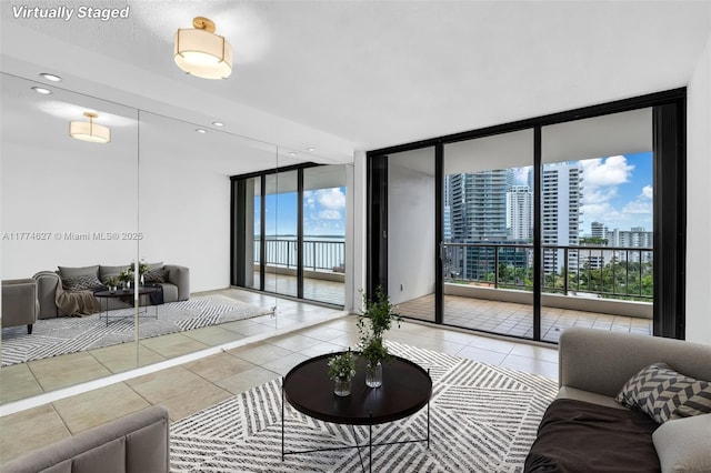 1581 Brickell Ave Unit 808, Miami, FL 33129 - living area featuring a wall of windows, tile patterned floors, a view of city, and recessed lighting