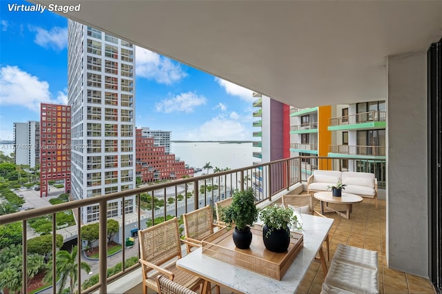 1581 Brickell Ave Unit 808, Miami, FL 33129 - balcony featuring a city view, a water view, and outdoor lounge area