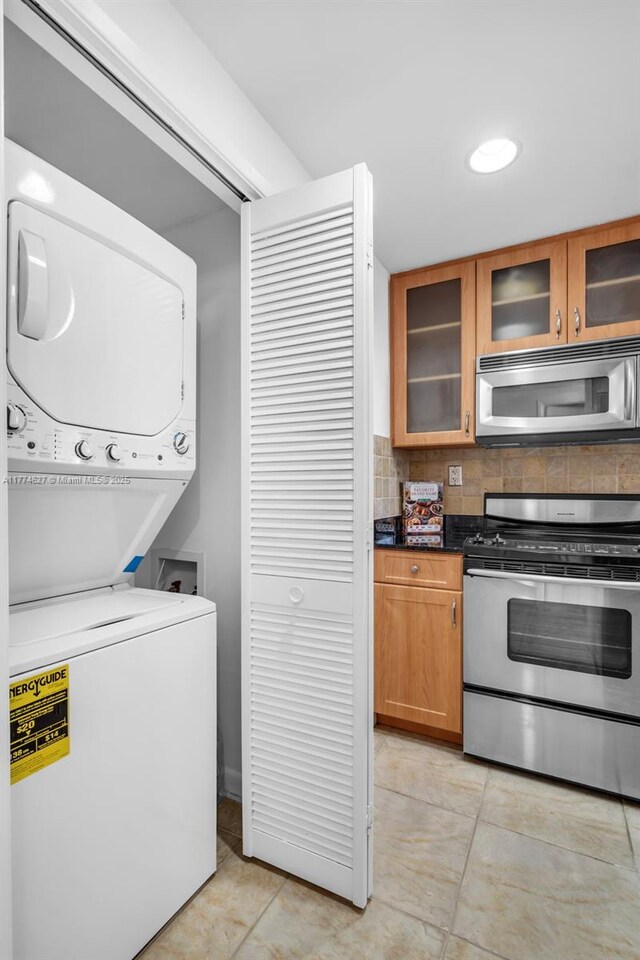 1581 Brickell Ave Unit 808, Miami, FL 33129 - laundry room with stacked washer and clothes dryer and light tile patterned floors