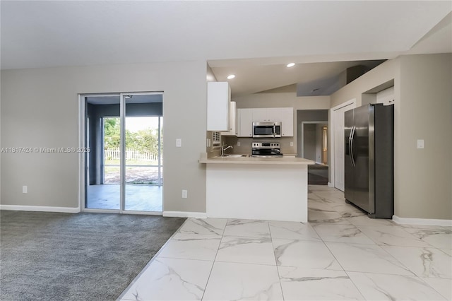 138 SW Bedford Rd, Port St Lucie, FL 34953 - kitchen with stainless steel appliances, baseboards, white cabinetry, a peninsula, and light countertops
