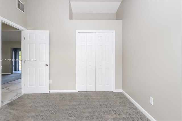 138 SW Bedford Rd, Port St Lucie, FL 34953 - unfurnished bedroom featuring baseboards, a closet, marble finish floors, and carpet floors