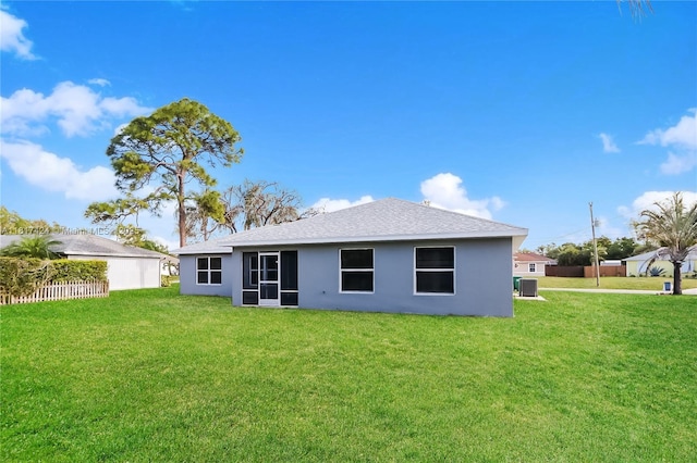 138 SW Bedford Rd, Port St Lucie, FL 34953 - back of house with stucco siding, a shingled roof, and central AC