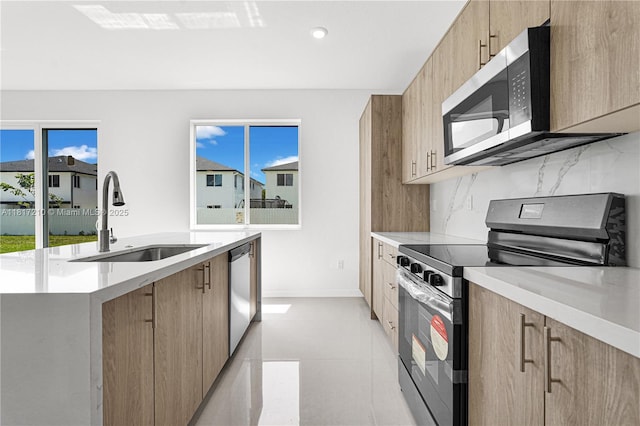 22481 SW 125th Ave Unit A, Miami, FL 33170 - kitchen featuring appliances with stainless steel finishes, a sink, light countertops, a center island with sink, and modern cabinets