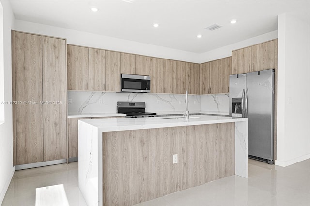 22481 SW 125th Ave Unit A, Miami, FL 33170 - kitchen featuring stainless steel appliances, modern cabinets, a sink, a center island with sink, and backsplash