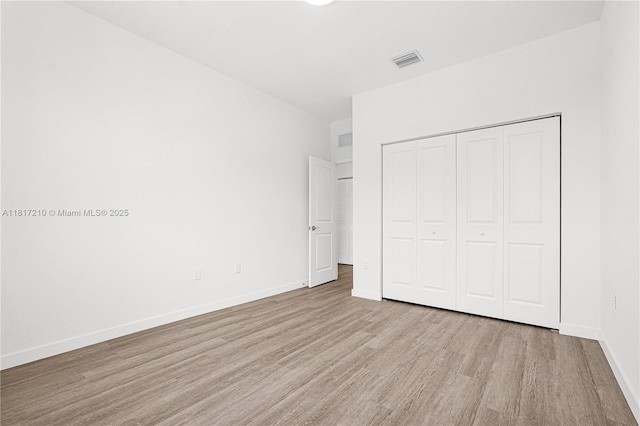 22481 SW 125th Ave Unit A, Miami, FL 33170 - unfurnished bedroom featuring wood finished floors, a closet, and baseboards