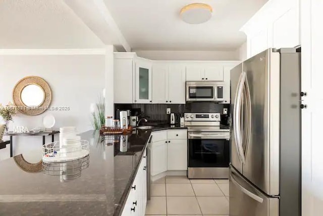 5601 Collins Ave Unit 923, Miami Beach, FL 33140 - kitchen featuring stainless steel appliances, white cabinets, and light tile patterned floors