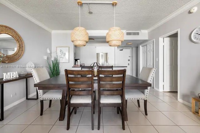 5601 Collins Ave Unit 923, Miami Beach, FL 33140 - dining area with ornamental molding, a textured ceiling, light tile patterned floors, and baseboards