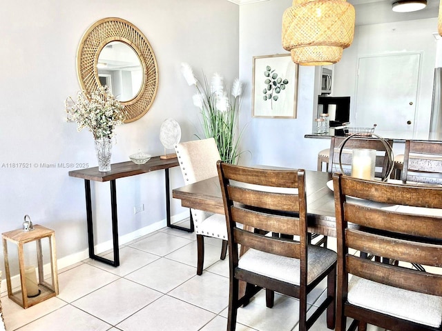 5601 Collins Ave Unit 923, Miami Beach, FL 33140 - dining area featuring light tile patterned floors and baseboards