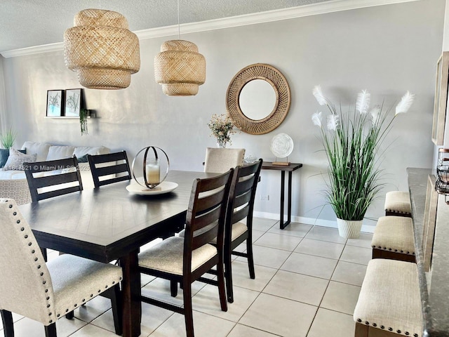 5601 Collins Ave Unit 923, Miami Beach, FL 33140 - dining space featuring a textured ceiling, light tile patterned floors, crown molding, and baseboards
