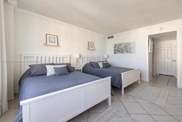 5601 Collins Ave Unit 923, Miami Beach, FL 33140 - bedroom featuring ornamental molding, a textured ceiling, and light tile patterned floors