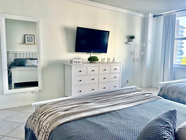 5601 Collins Ave Unit 923, Miami Beach, FL 33140 - bedroom with light tile patterned floors, ornamental molding, and baseboards