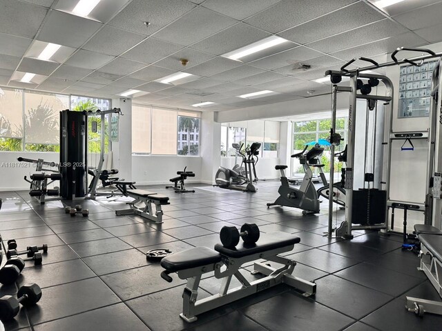 5601 Collins Ave Unit 923, Miami Beach, FL 33140 - workout area featuring a drop ceiling and baseboards