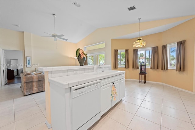 5402 NW 110th Ave, Doral, FL 33178 - kitchen with white dishwasher, tile countertops, light tile patterned floors, a sink, and lofted ceiling