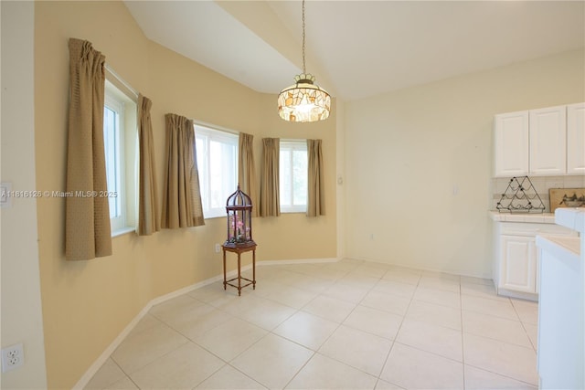 5402 NW 110th Ave, Doral, FL 33178 - unfurnished dining area featuring baseboards, a chandelier, and light tile patterned floors