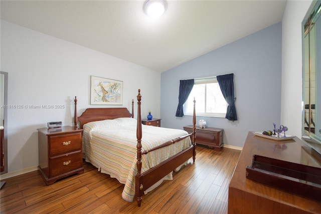 5402 NW 110th Ave, Doral, FL 33178 - bedroom featuring vaulted ceiling, wood finished floors, and baseboards