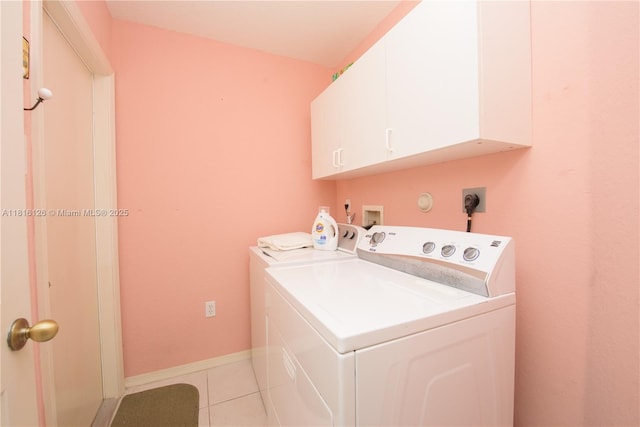 5402 NW 110th Ave, Doral, FL 33178 - laundry area featuring washing machine and clothes dryer, cabinet space, light tile patterned floors, and baseboards