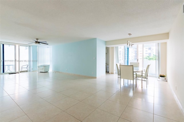 1360 S Ocean Blvd Unit 304, Pompano Beach, FL 33062 - unfurnished room with a chandelier, light tile patterned floors, a textured ceiling, and a ceiling fan