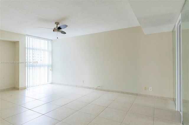 1360 S Ocean Blvd Unit 304, Pompano Beach, FL 33062 - spare room with a ceiling fan, light tile patterned floors, baseboards, and a textured ceiling