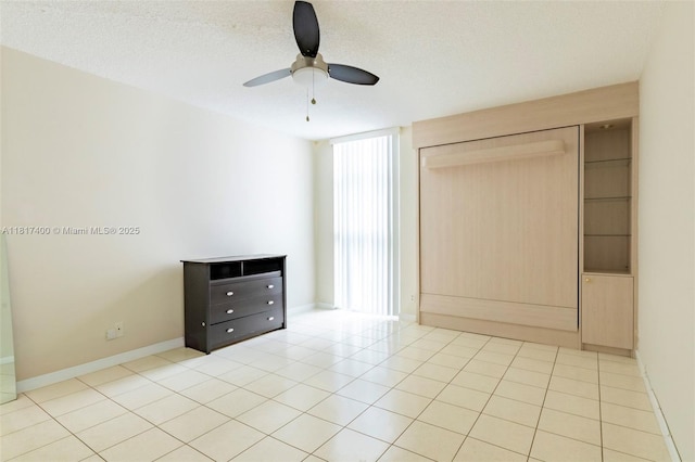 1360 S Ocean Blvd Unit 304, Pompano Beach, FL 33062 - unfurnished bedroom with baseboards, ceiling fan, a textured ceiling, and light tile patterned floors