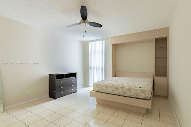 1360 S Ocean Blvd Unit 304, Pompano Beach, FL 33062 - unfurnished bedroom featuring baseboards, ceiling fan, light tile patterned flooring, and a textured ceiling