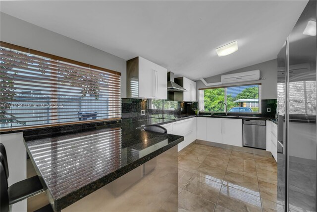 11020 SW 55th St, Miami, FL 33165 - kitchen with stainless steel appliances, wall chimney range hood, a wall unit AC, decorative backsplash, and a peninsula