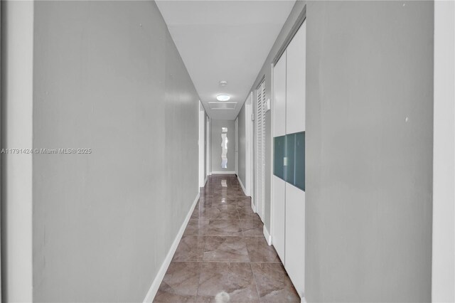 11020 SW 55th St, Miami, FL 33165 - corridor featuring light marble finish flooring and baseboards