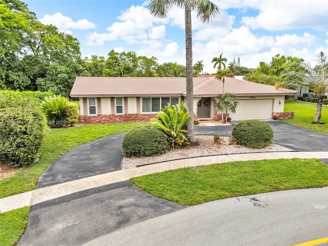 7541 SW 9th St, Plantation, FL 33317 - single story home featuring asphalt driveway, a tiled roof, stucco siding, a front yard, and stone siding