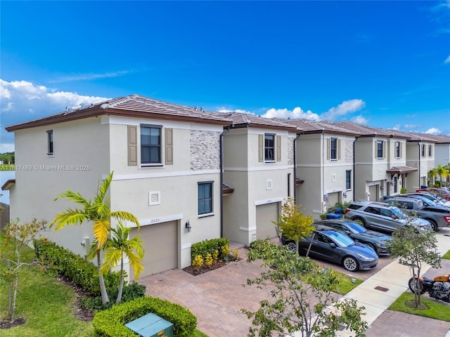 10225 SW 231st Ln, Miami, FL 33190 - view of property with an attached garage, decorative driveway, and a residential view