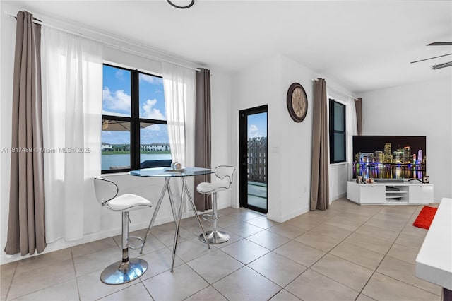 10225 SW 231st Ln, Miami, FL 33190 - dining space with a water view, light tile patterned flooring, baseboards, and ceiling fan