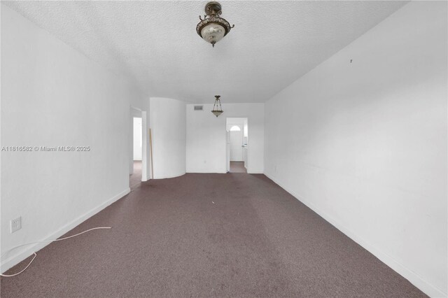 3401 SW 10th St Unit 2B, Miami, FL 33135 - unfurnished room featuring a textured ceiling, carpet flooring, and baseboards