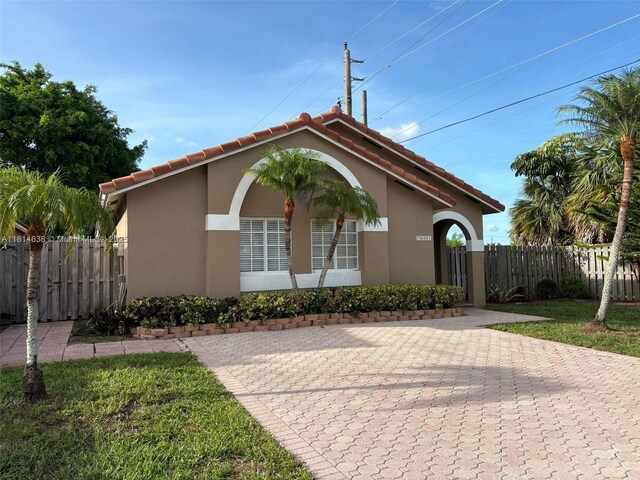 7601 NW 166th Ter, Hialeah, FL 33015 - view of front facade with stucco siding and a tiled roof