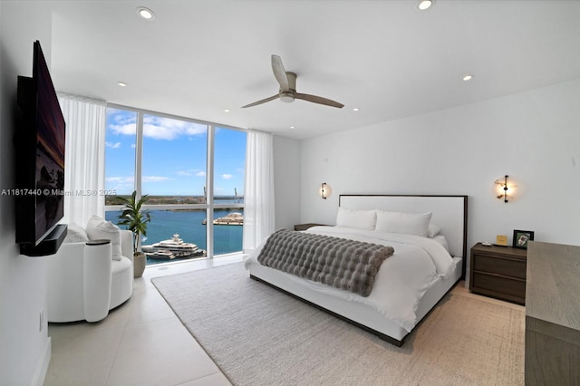 450 Alton Rd Unit 2007, Miami Beach, FL 33139 - bedroom with a water view, expansive windows, tile patterned floors, recessed lighting, and ceiling fan