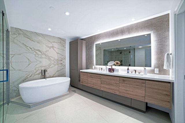 450 Alton Rd Unit 2007, Miami Beach, FL 33139 - full bathroom featuring double vanity, a marble finish shower, tile walls, a freestanding bath, and recessed lighting