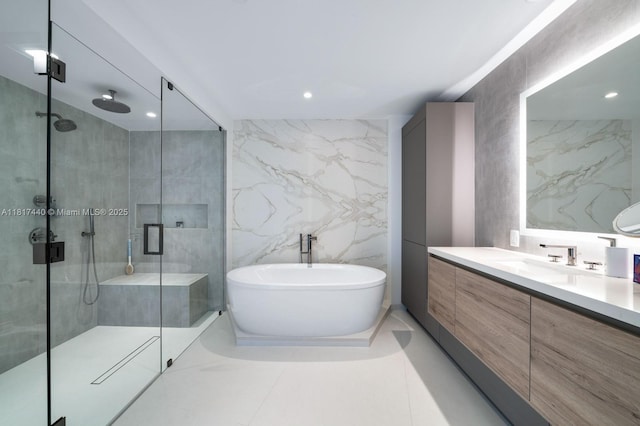 450 Alton Rd Unit 2007, Miami Beach, FL 33139 - full bath with a stall shower, tile walls, a freestanding bath, vanity, and recessed lighting