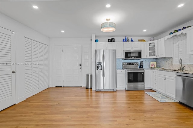 200 Wrenn St Ph 701, Plantation Key, FL 33070 - kitchen with stainless steel appliances, a sink, light stone countertops, white cabinetry, and recessed lighting