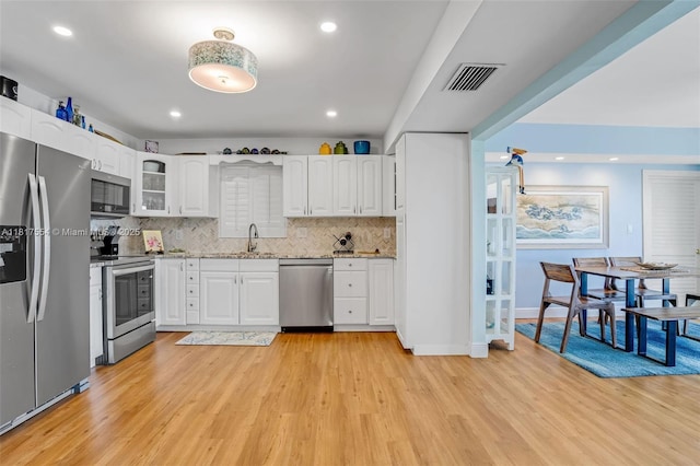 200 Wrenn St Ph 701, Plantation Key, FL 33070 - kitchen featuring appliances with stainless steel finishes, a sink, light wood-type flooring, tasteful backsplash, and recessed lighting