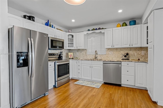 200 Wrenn St Ph 701, Plantation Key, FL 33070 - kitchen with appliances with stainless steel finishes, white cabinets, backsplash, glass insert cabinets, and recessed lighting