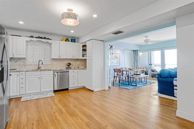 200 Wrenn St Ph 701, Plantation Key, FL 33070 - kitchen with stainless steel appliances, a sink, backsplash, light stone countertops, and a ceiling fan